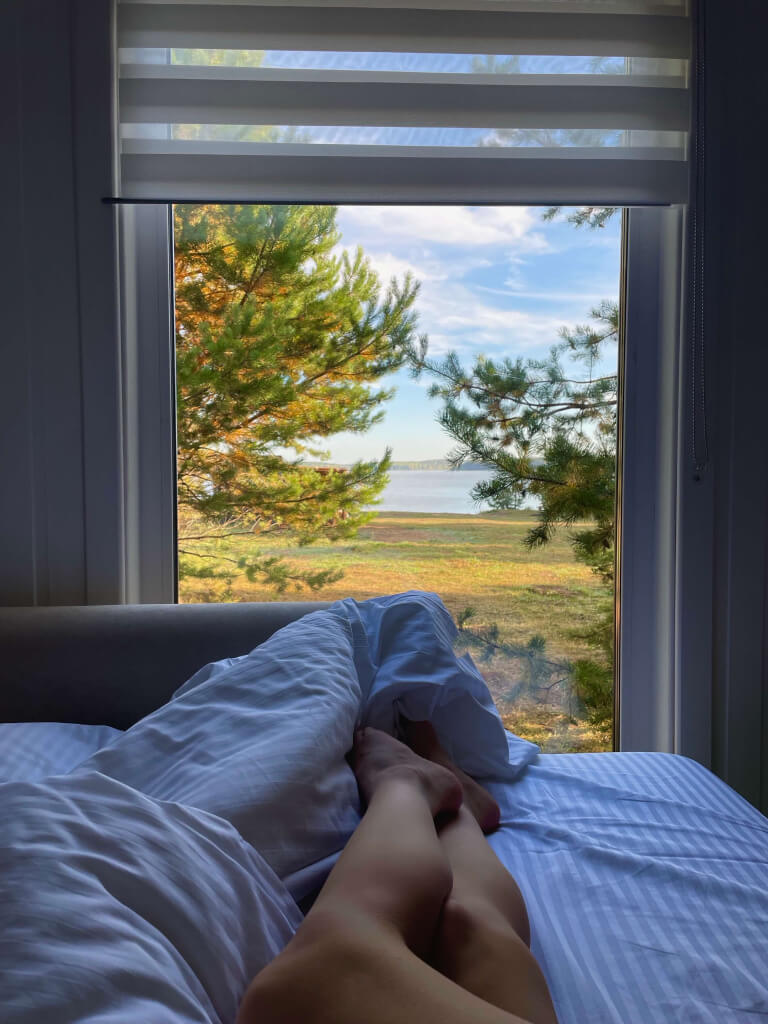 Кровать установлена у панорамного окна.