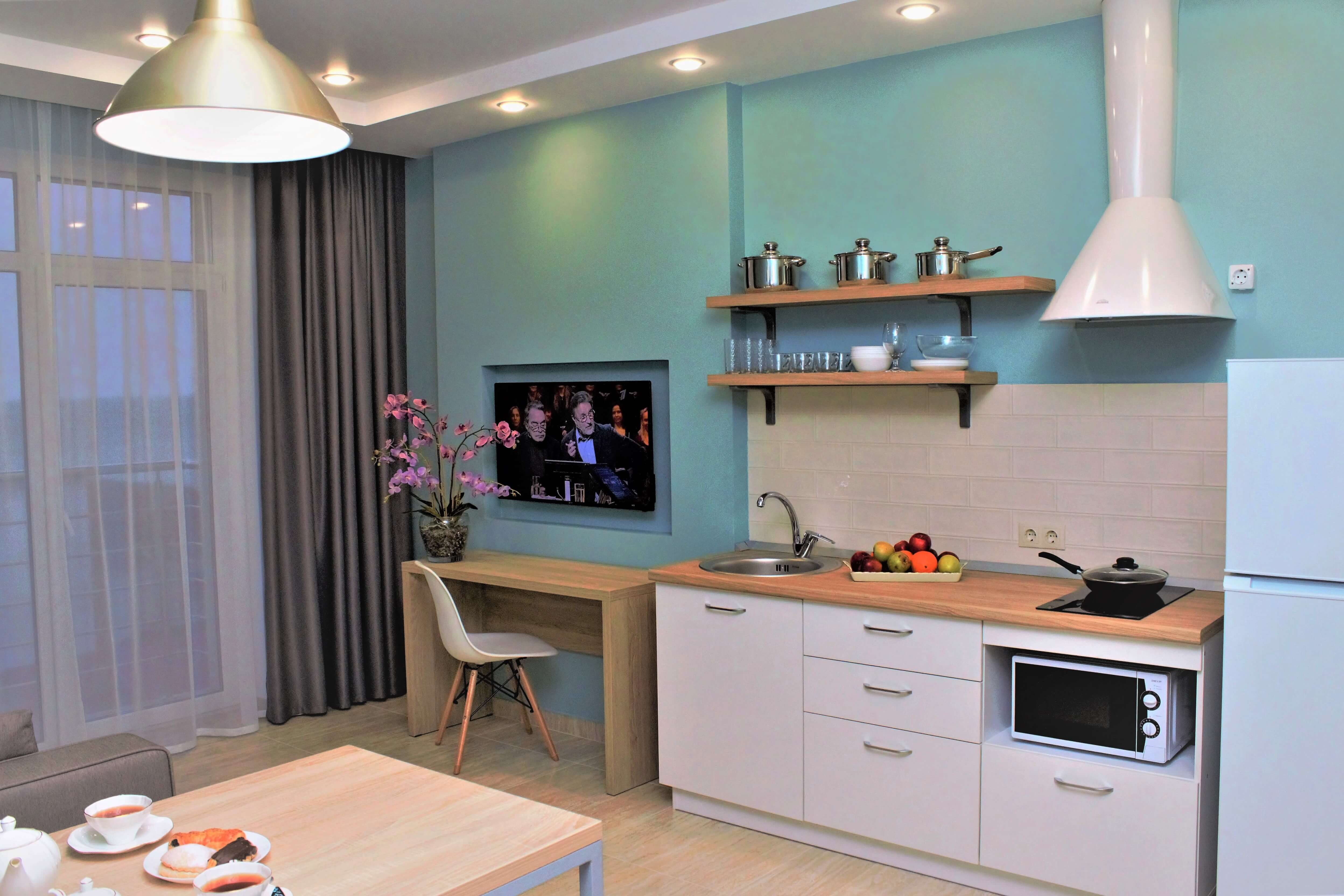 Кухонная зона и небольшой столик у телевизора.