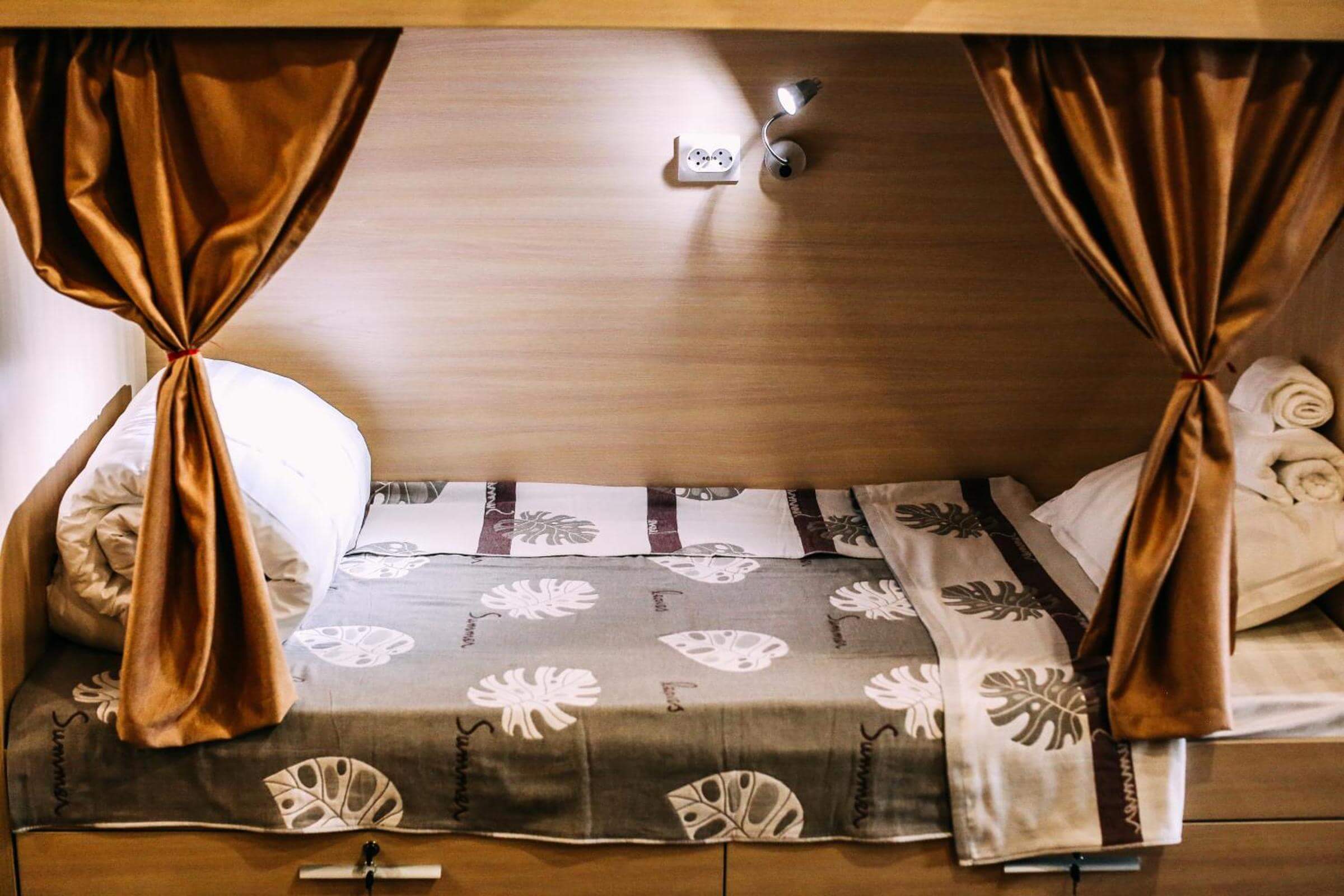Пример спального места. Застеленная кровать, покрывало, полотенца.