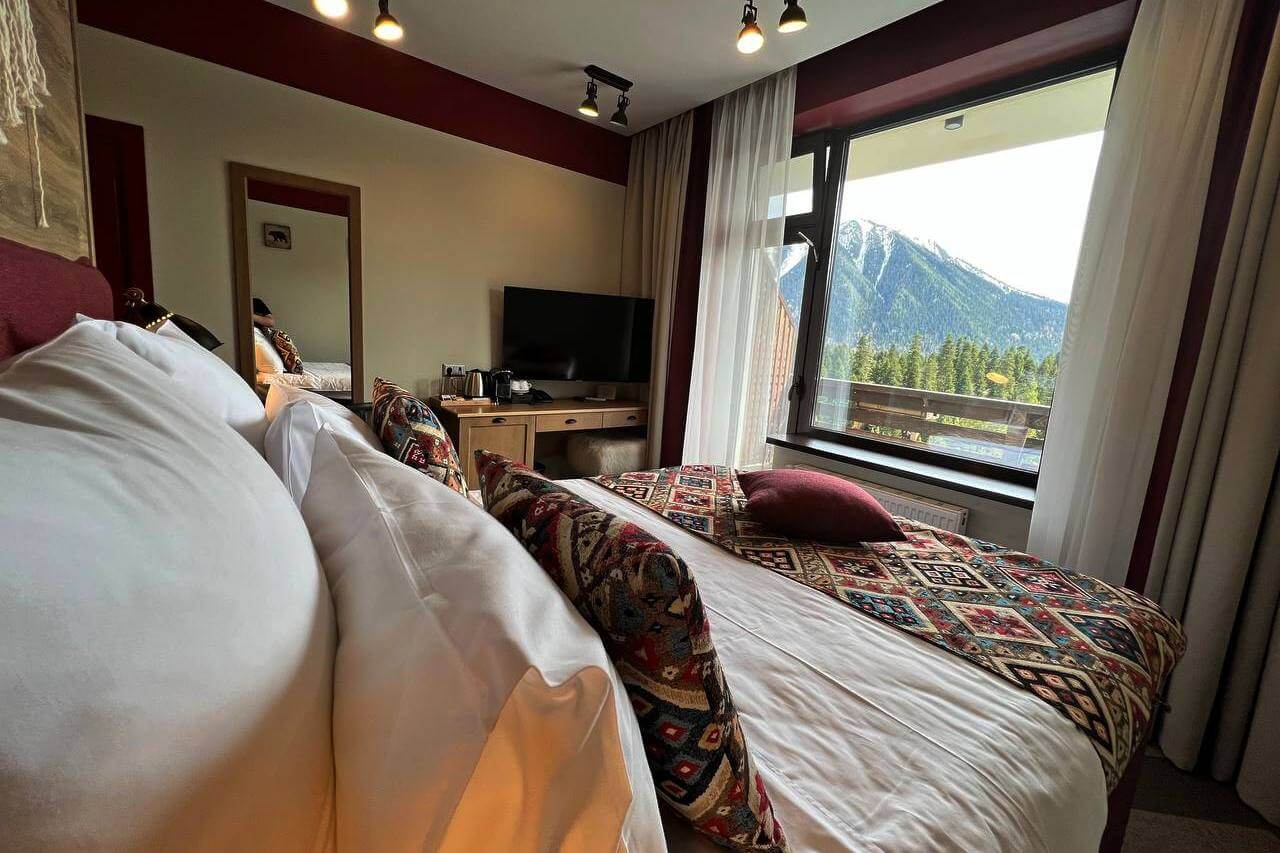 Кровать украшена красивым саше и подушками с кавказским орнаментом.
